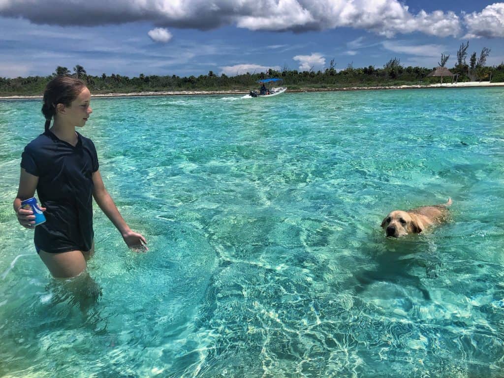 Sadie with Ganesh the dog in water at Cozumel Pearl Farm